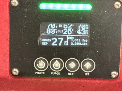 Dehumidifier display showing inlet and outlet humidity readings