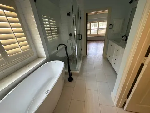 Rebuilt bathroom with a freestanding tub, glass shower and double vanity
