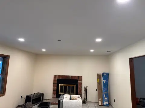 Repaired family room with new ceiling, recessed lights and fresh paint